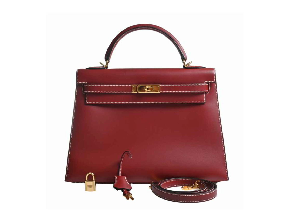 Hermes Kelly 32 handbag in a burgundy, comes with a shoulder strap, clochette, and Cadena