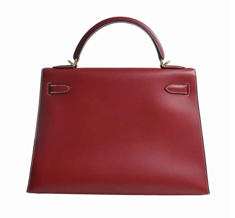 Hermes Kelly 32 handbag in a burgundy, comes with a shoulder strap, clochette, and Cadena