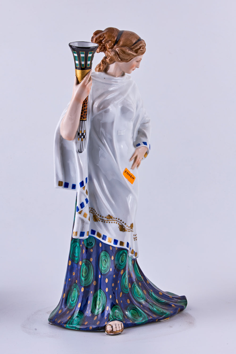 Hand-painted porcelain figurine of a woman with a torch