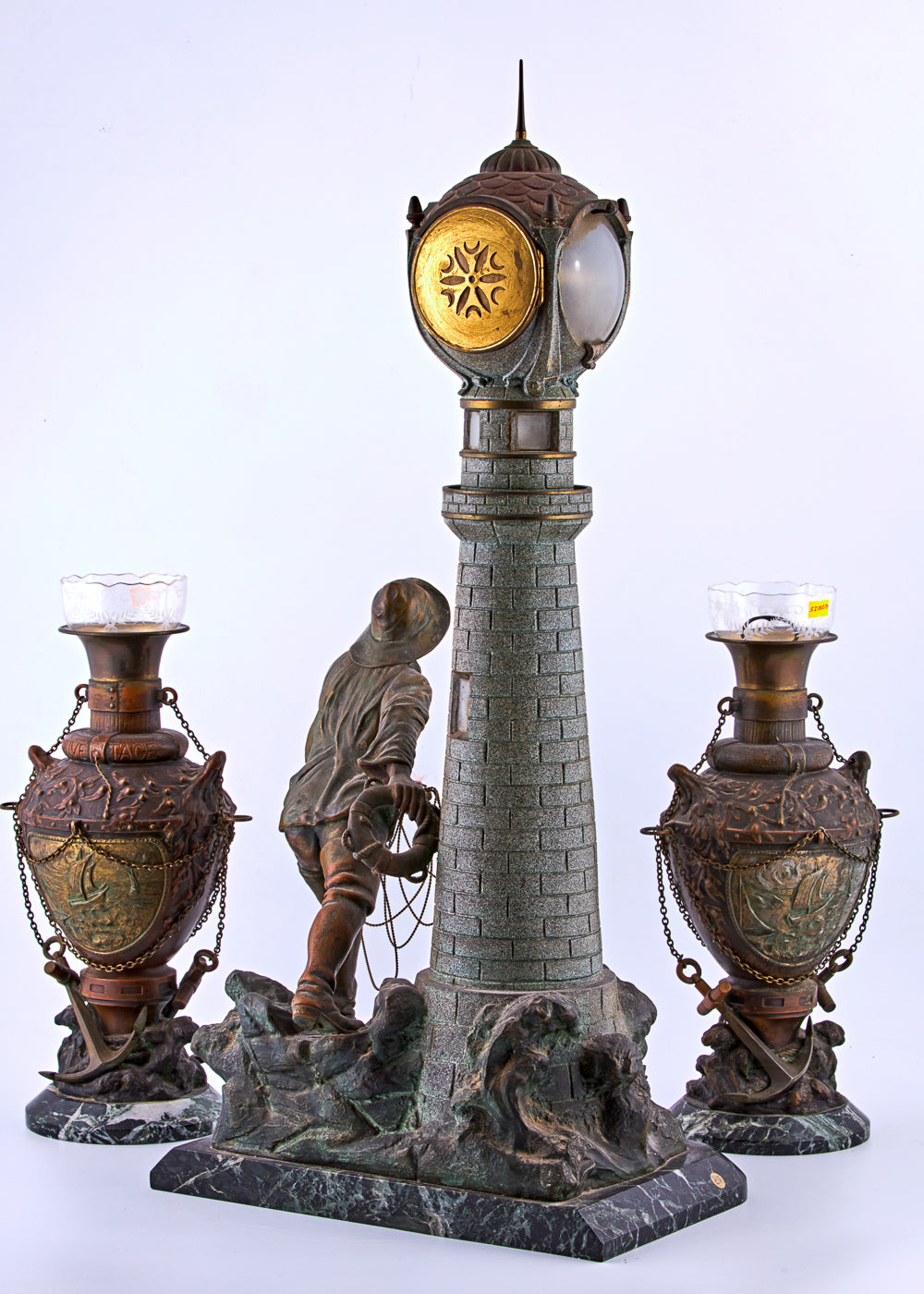 Spelter set presenting a lighthouse at sea and a fisherman