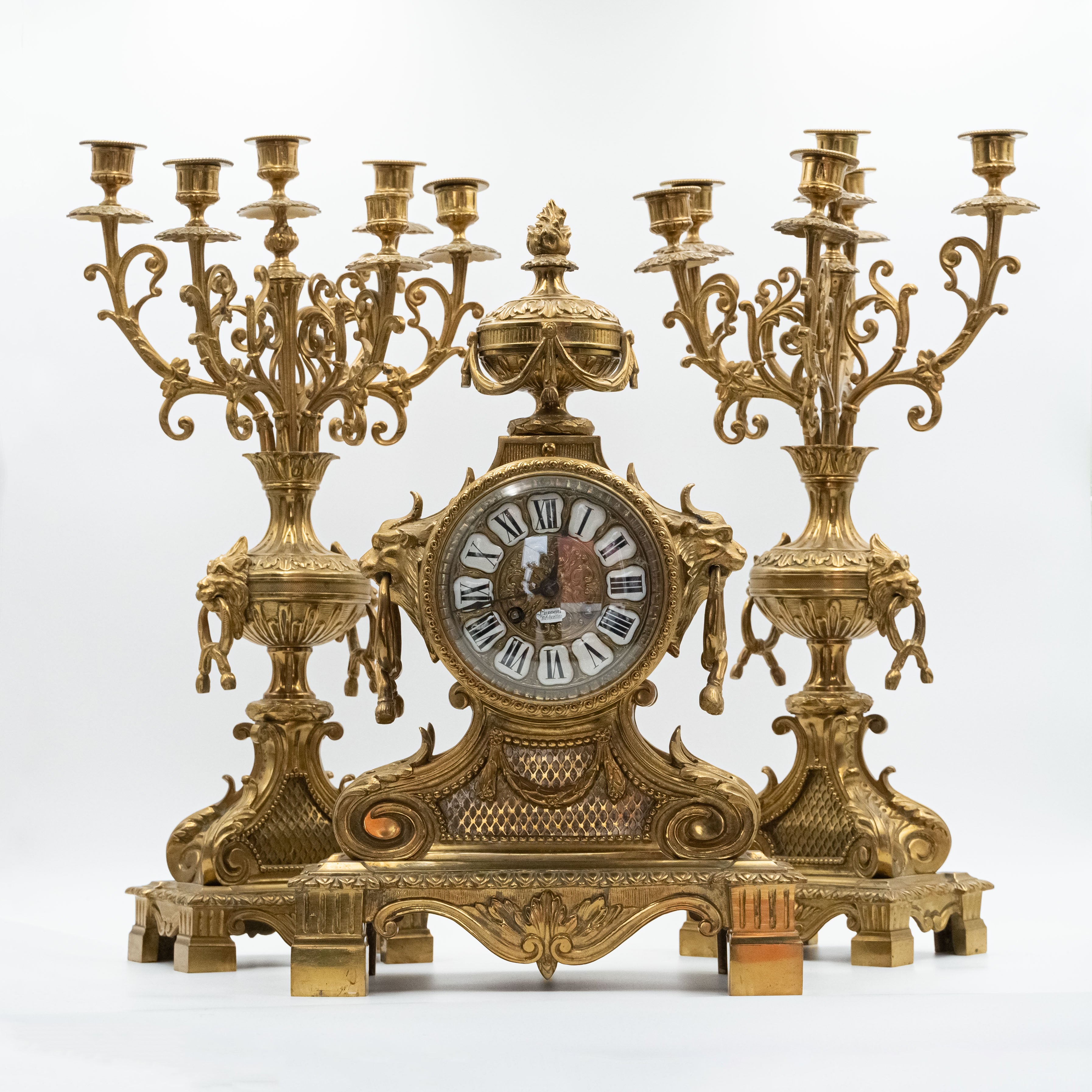 Antique Eclectic style bronze mantel clock with two candelabras in the style of Napoleon 3rd. decor