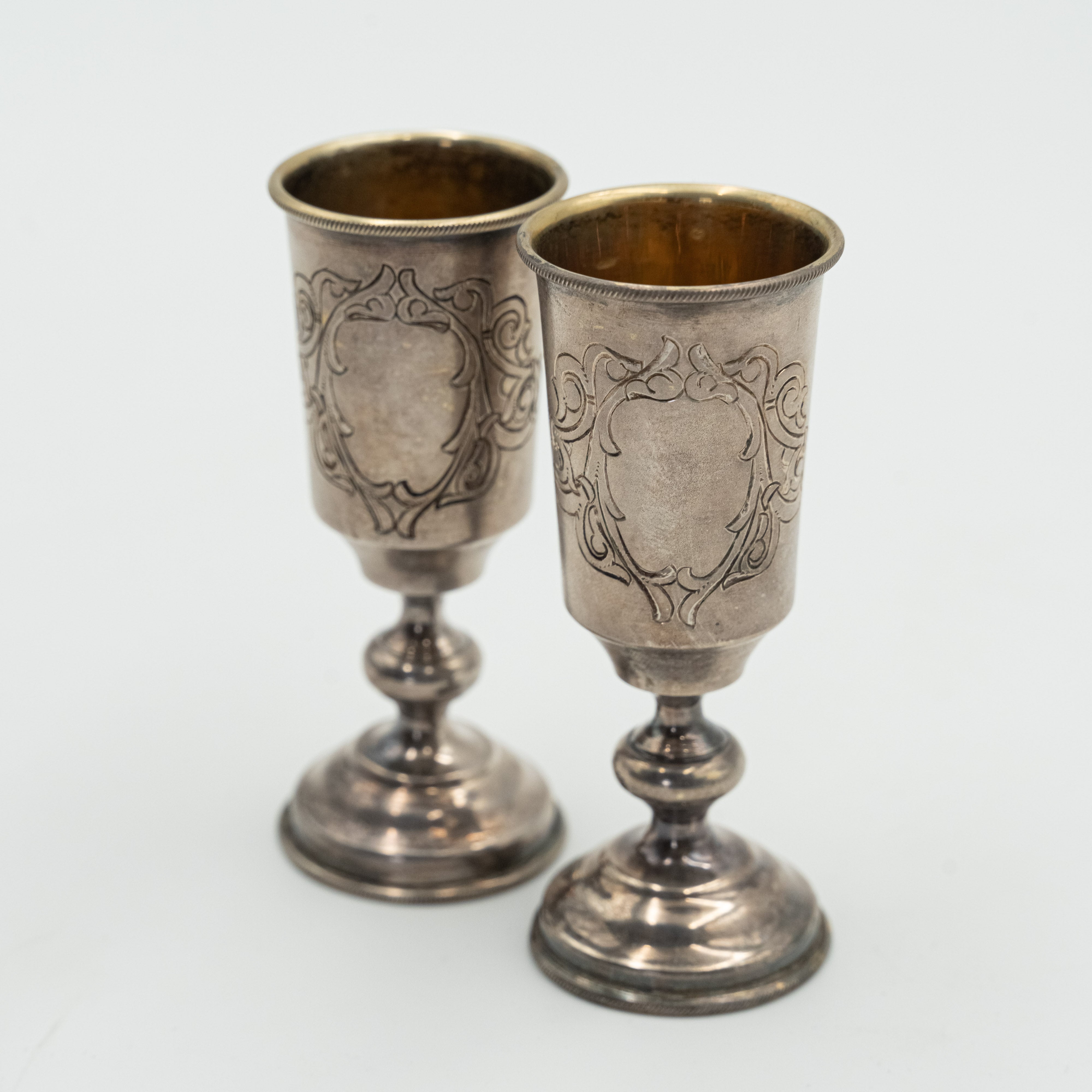 Pair of Russian sterling silver vodka cups by silversmith Sokolov