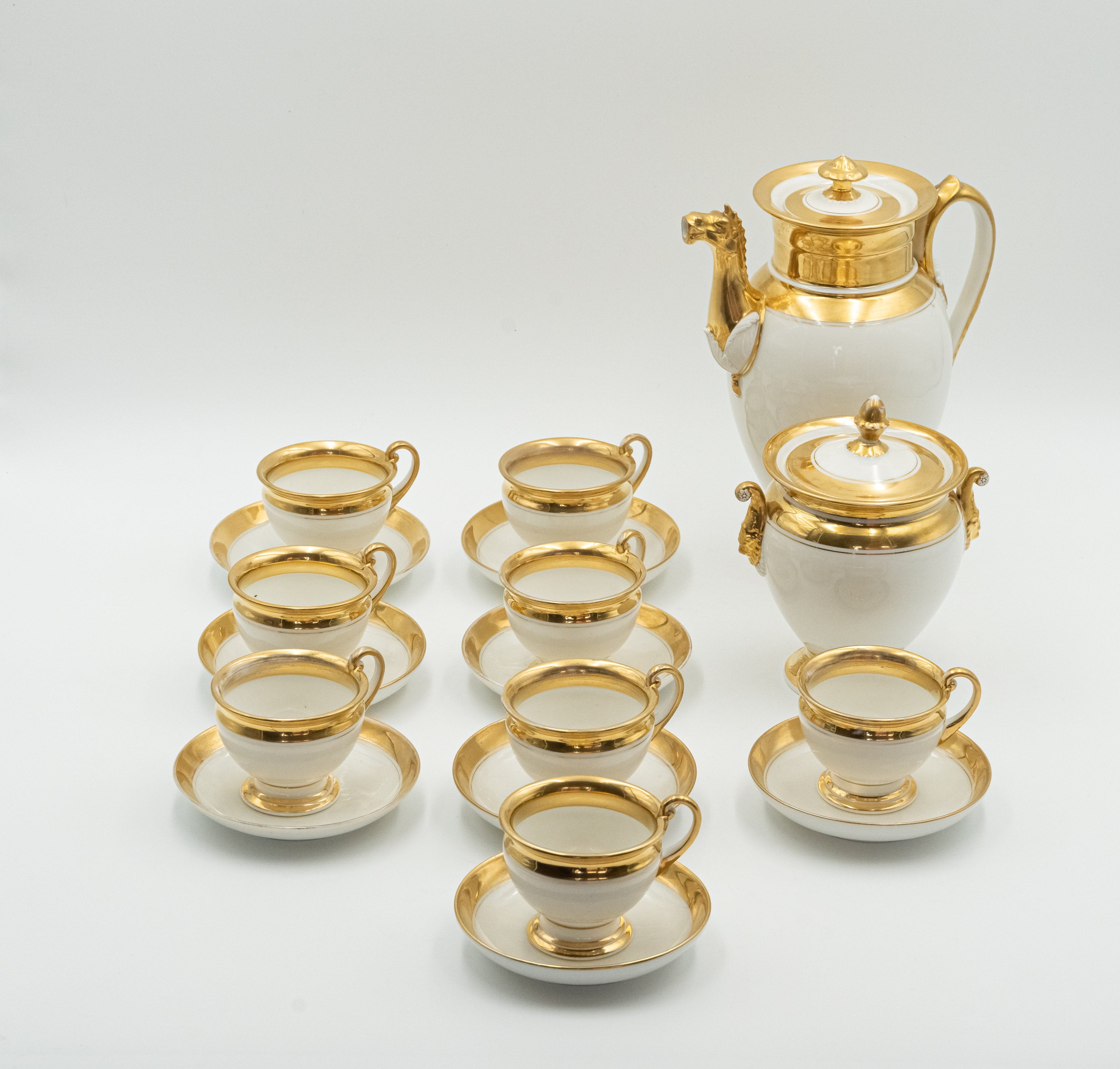 Late 19th century European porcelain coffee set for 8 persons worked out with a delicate relief that forms Mascarons