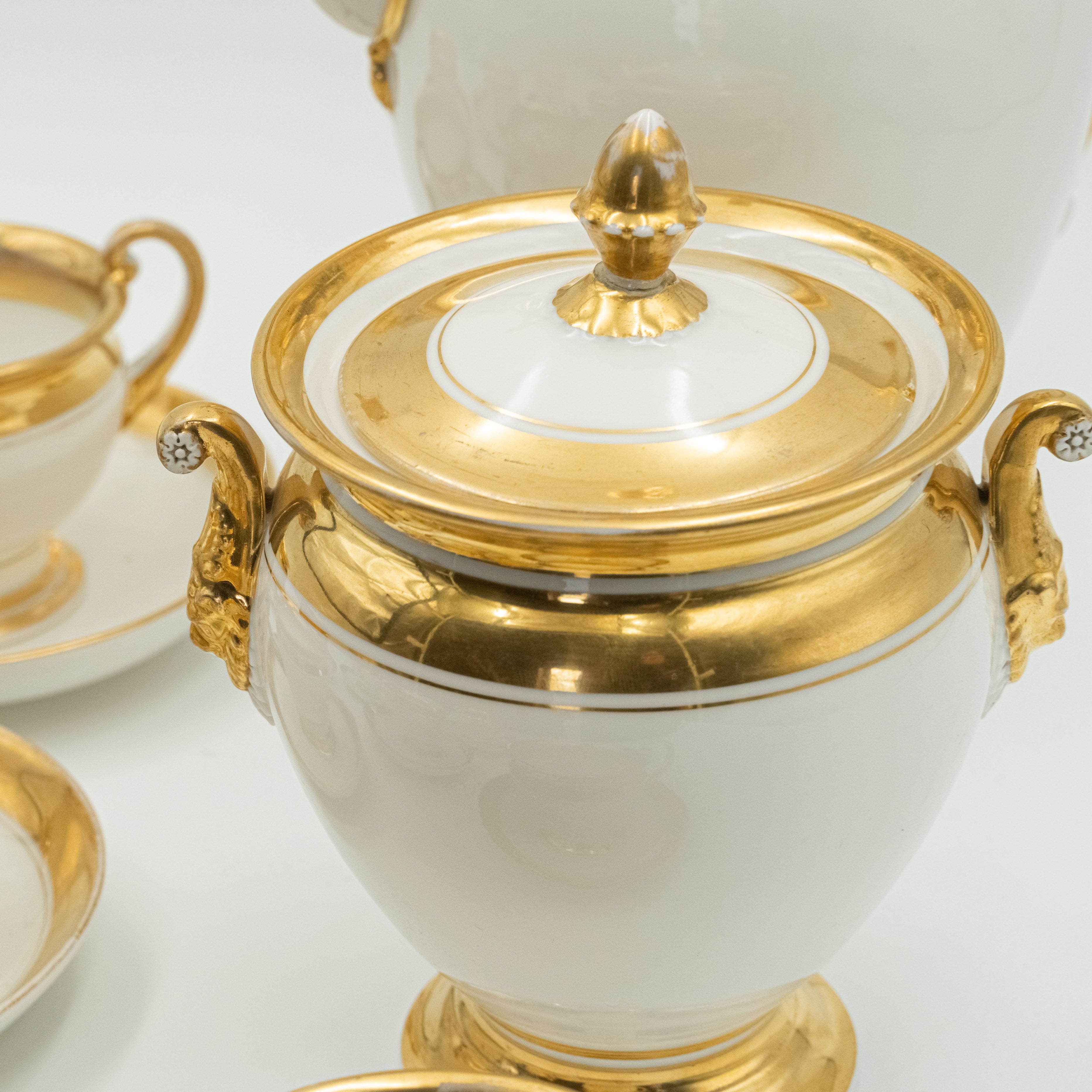 Late 19th century European porcelain coffee set for 8 persons worked out with a delicate relief that forms Mascarons